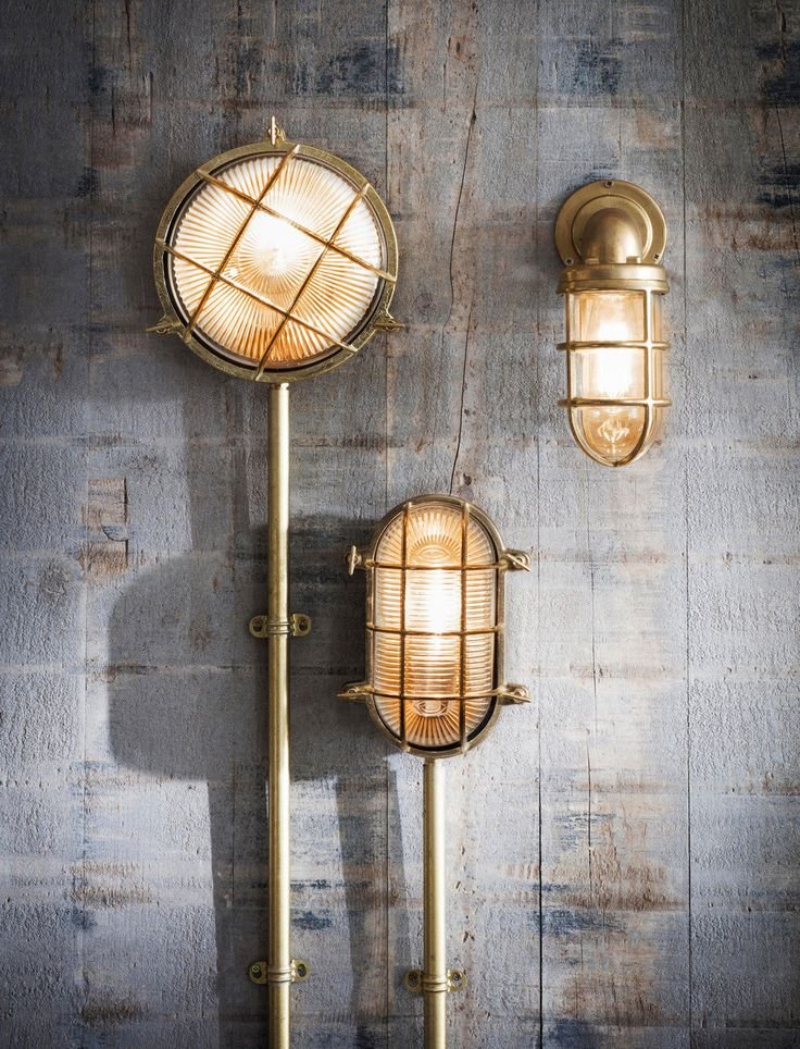 Three bulkhead wall lights on a timber wall